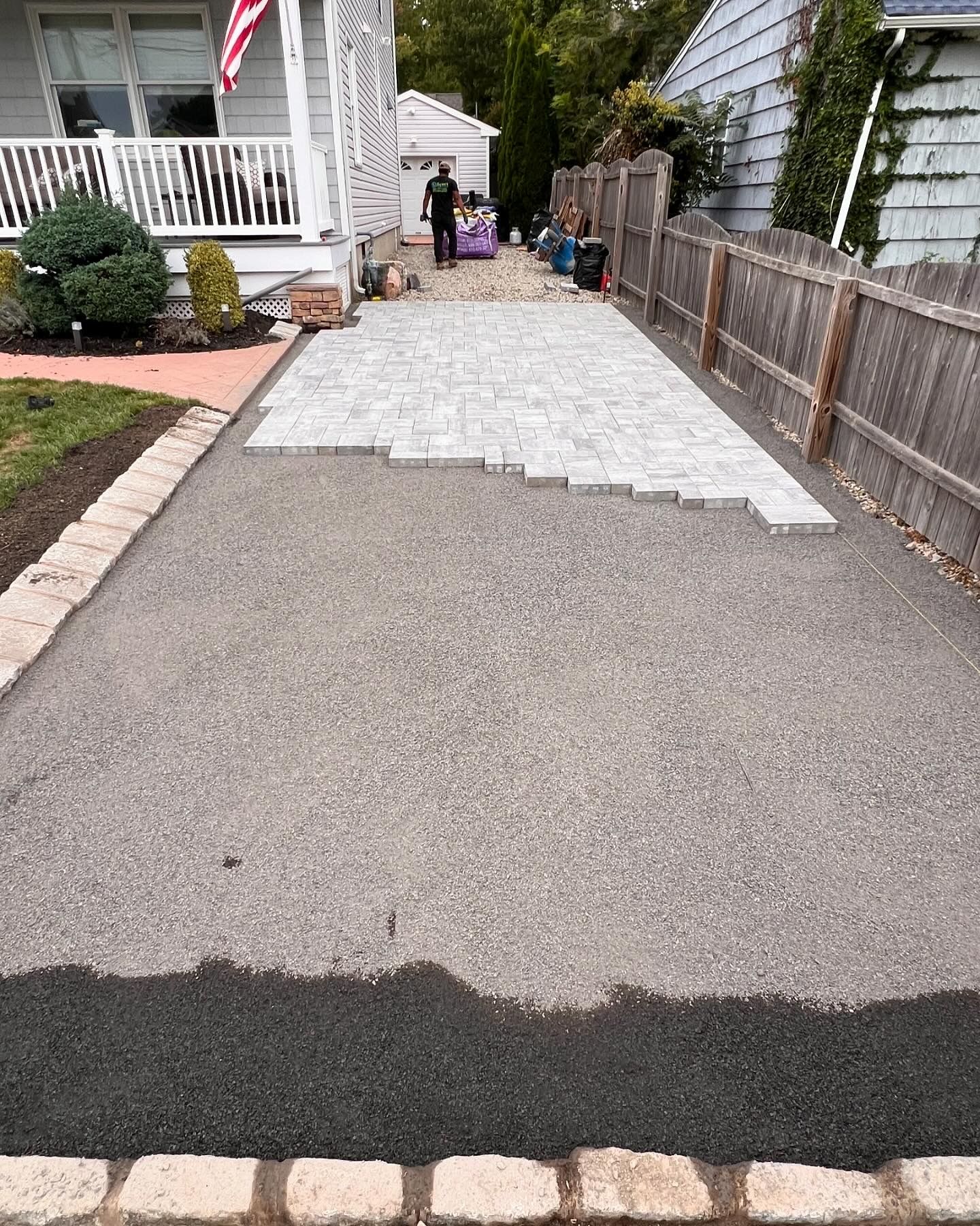 A driveway is being built in front of a house.