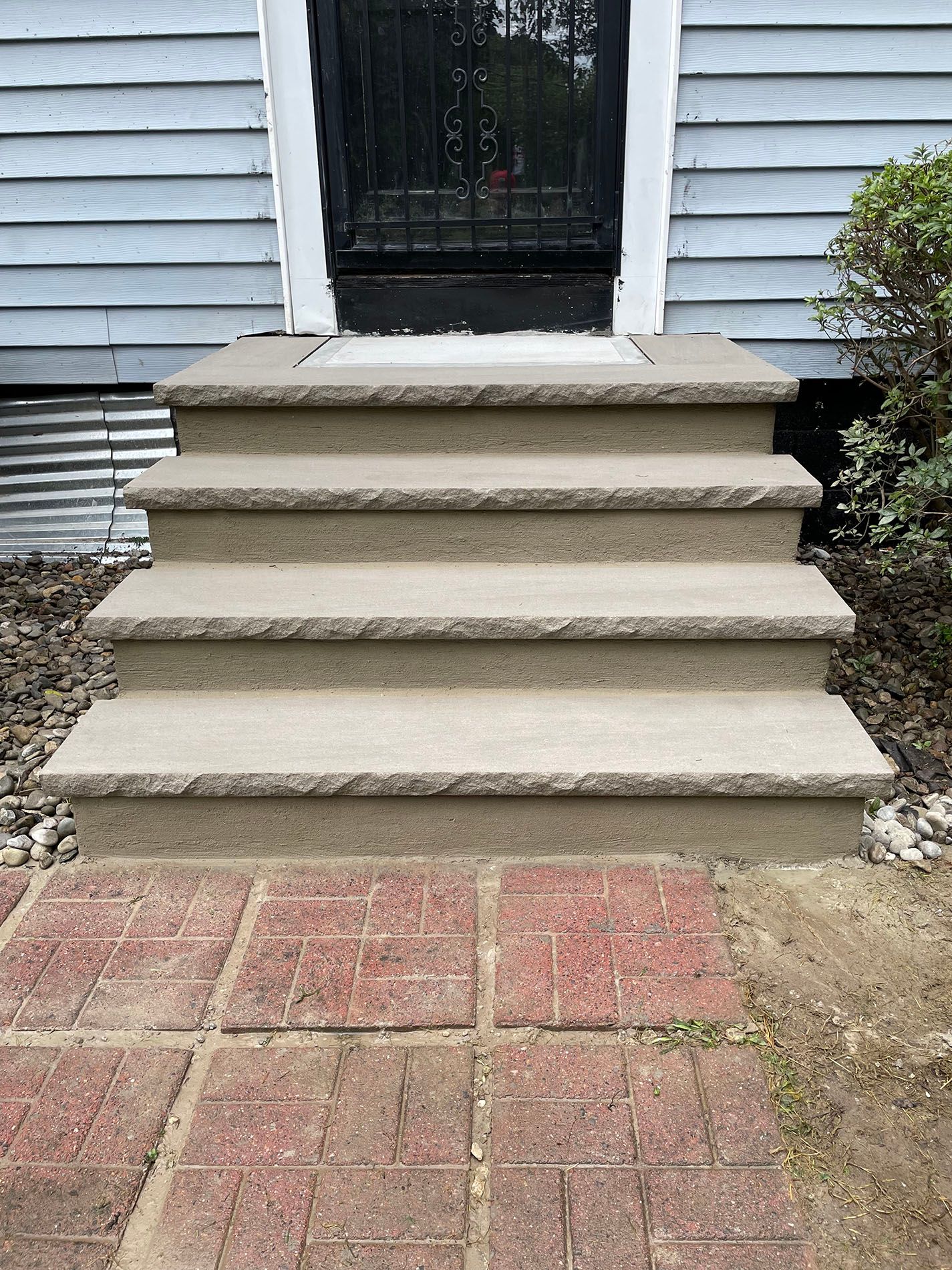 A set of stairs leading up to the front door of a house.