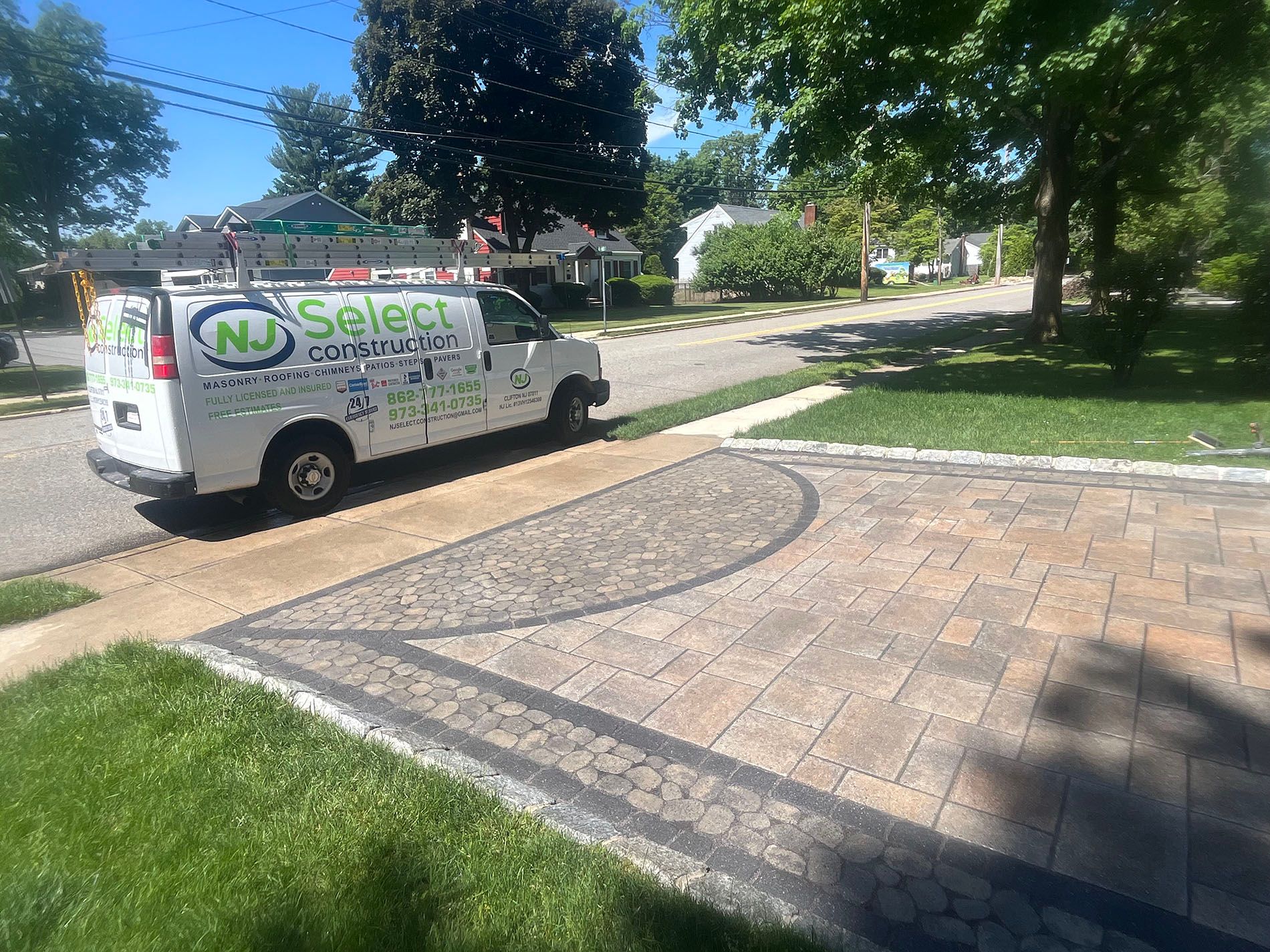 A white van is parked in the driveway of a house.