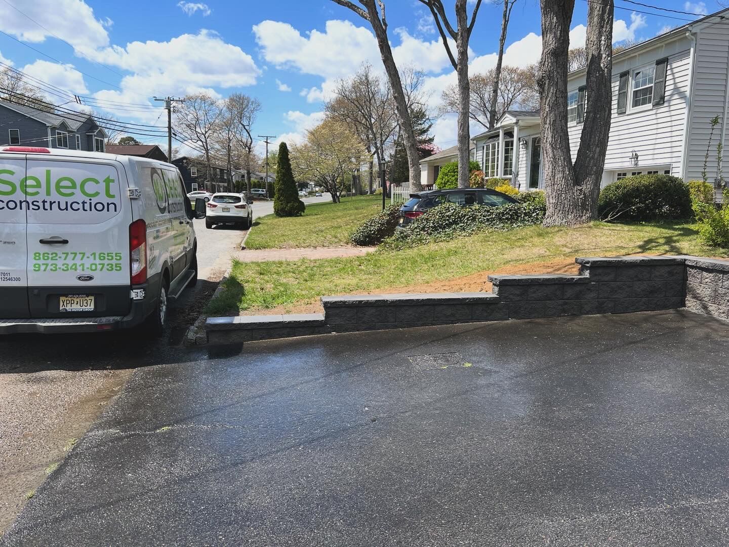 A select construction van is parked on the side of the road
