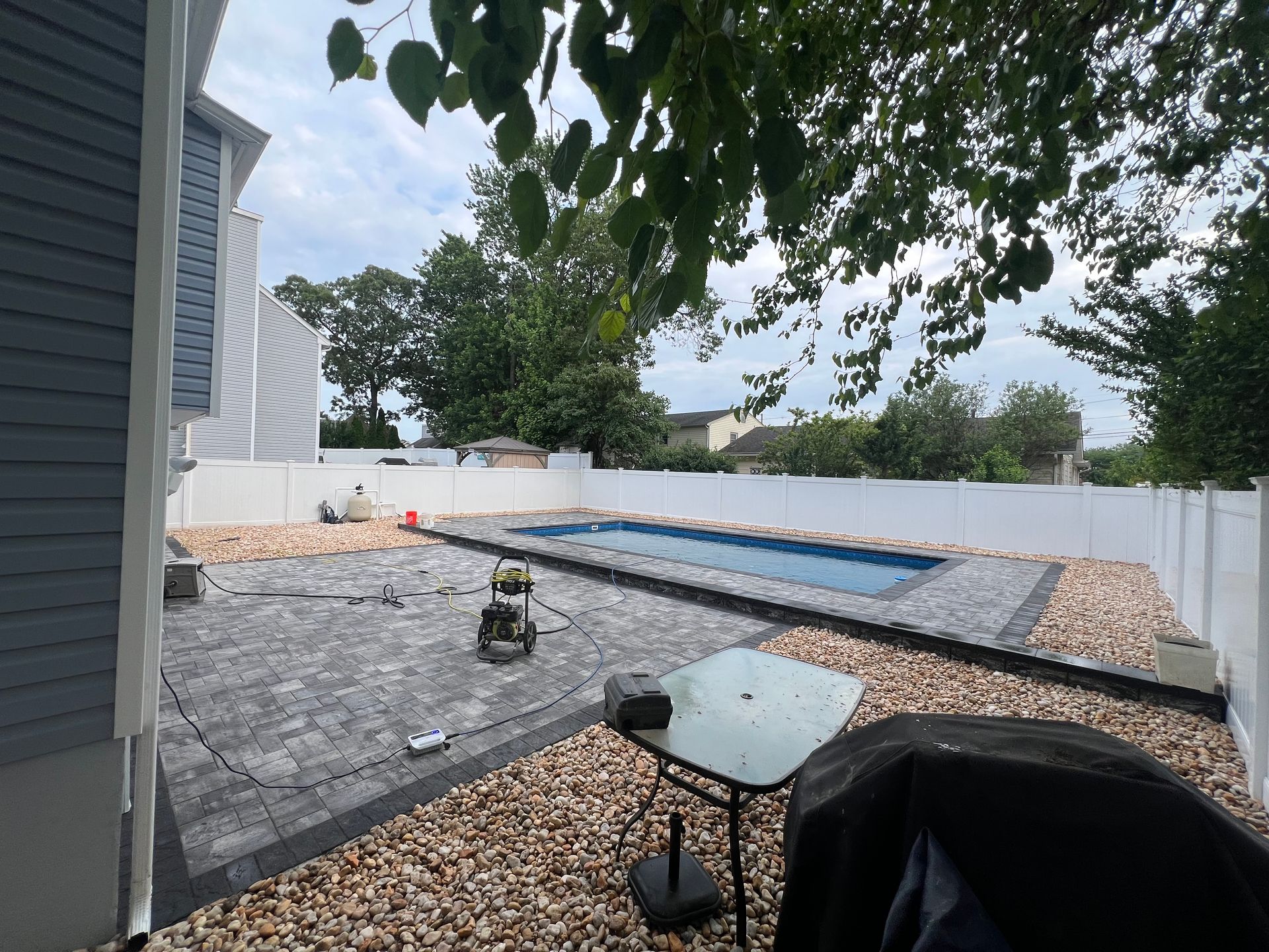 A swimming pool is being built in the backyard of a house.