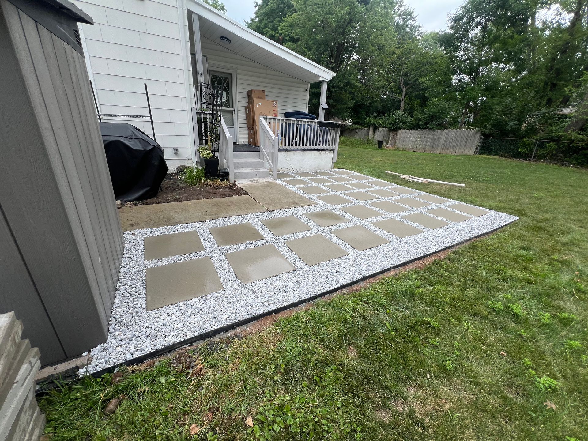 A house with a patio and a shed in the backyard.