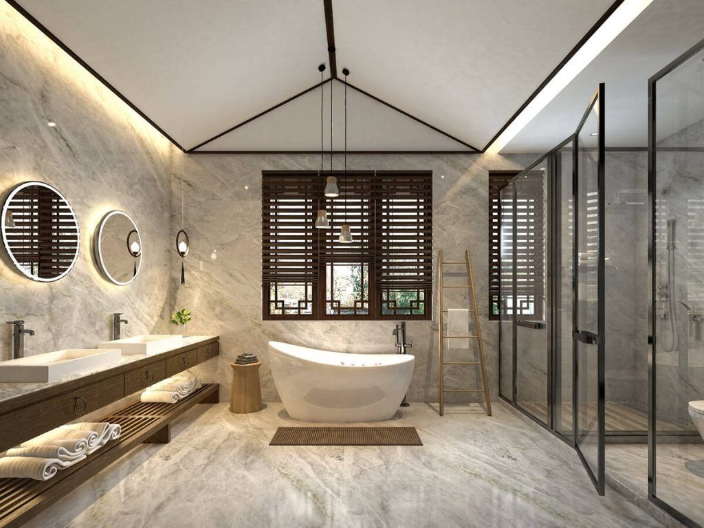 A luxury bathroom with marble walls, a freestanding white tub, dual sinks, wooden shutters, and a walk-in glass shower.