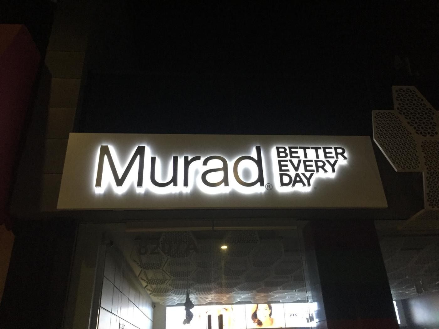 Sign for Murad, a business, with illuminated letters reading 