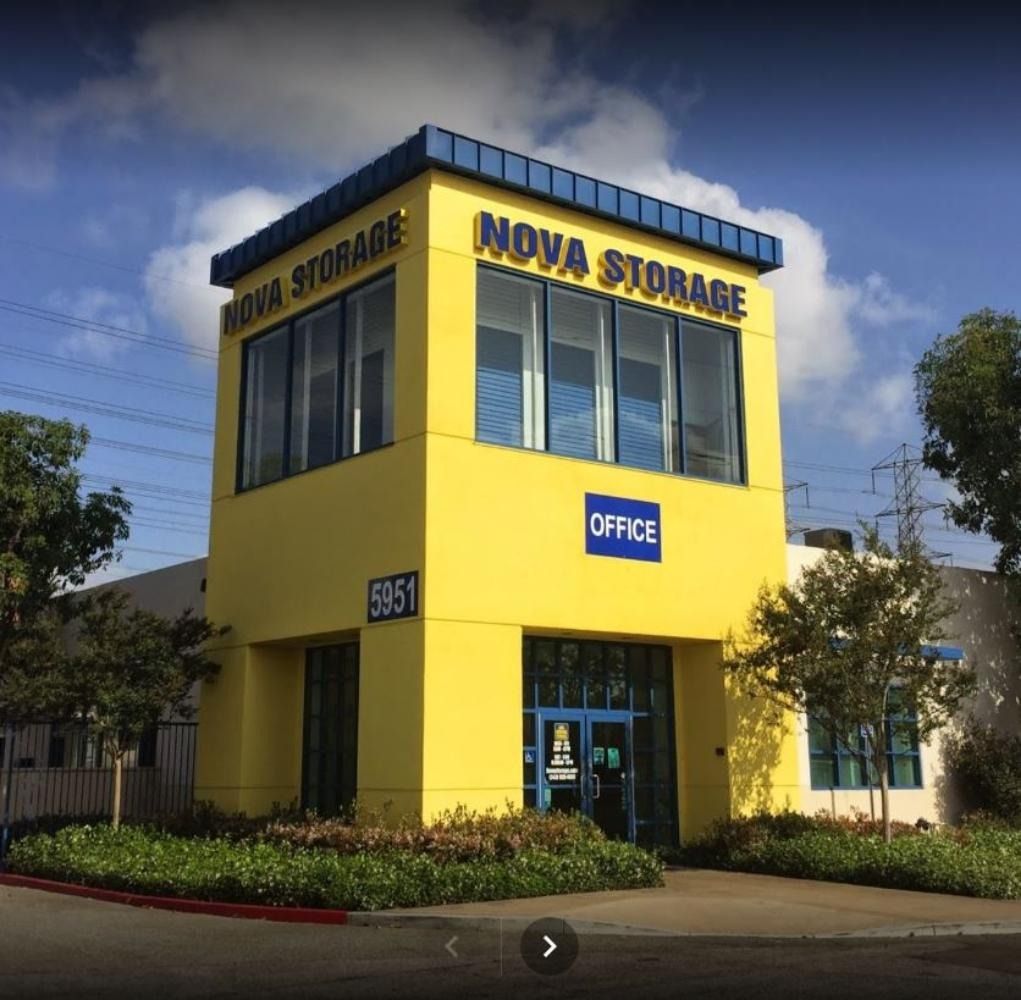 Yellow Nova Storage building with blue trim, 