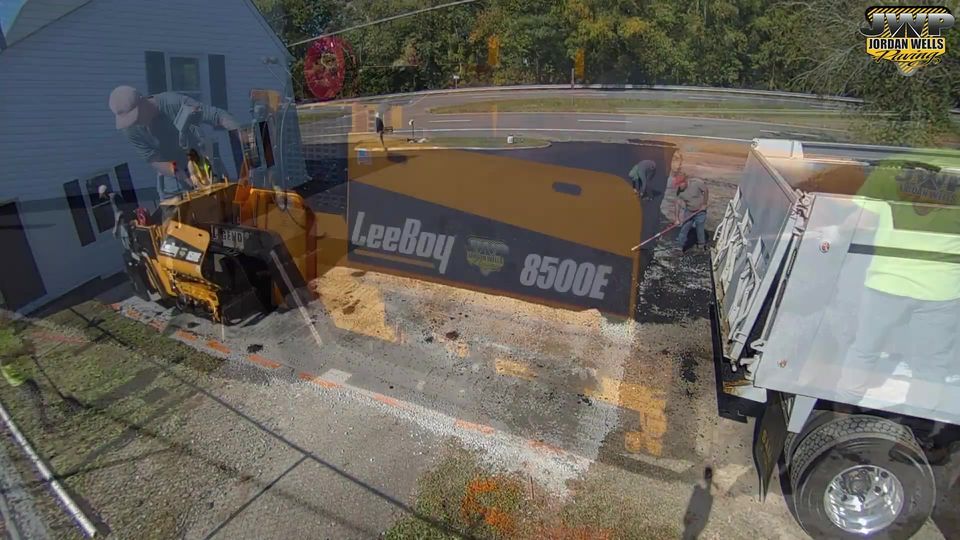 An aerial view of a construction site with a truck and a bulldozer.