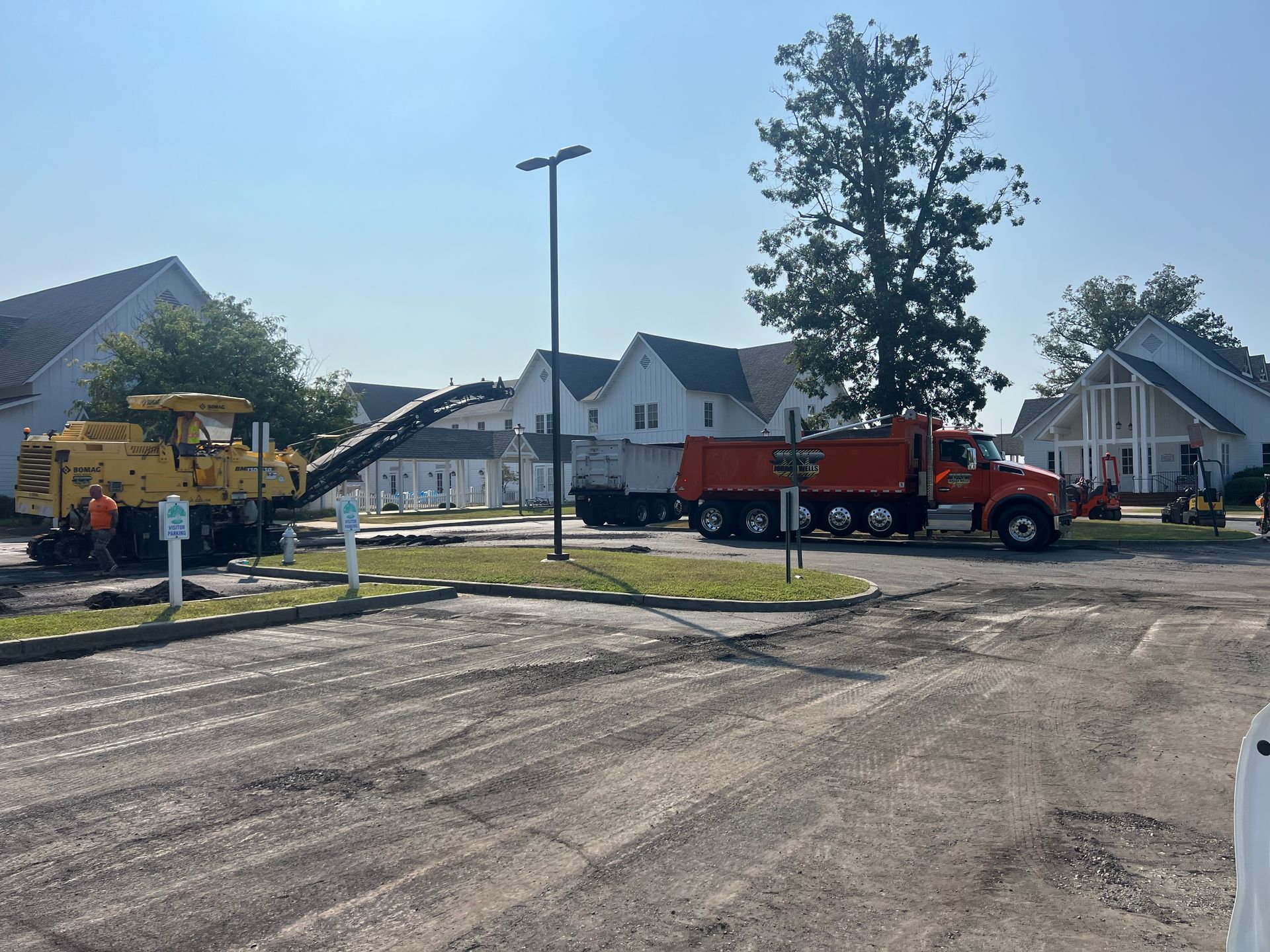 A red dump truck is parked in a parking lot.