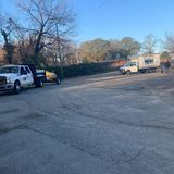 Two tow trucks are parked in a parking lot.