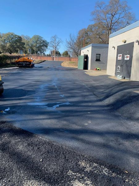 A truck is parked in a parking lot next to a building.
