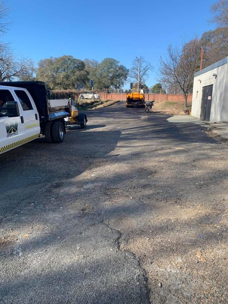 A truck is parked in a parking lot next to a building.