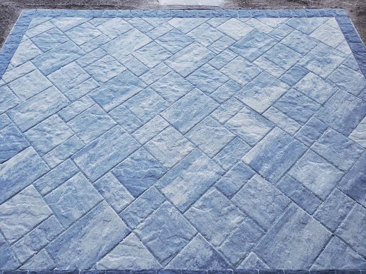 Blue and gray stone pavers arranged in a geometric pattern, forming a patio surface.