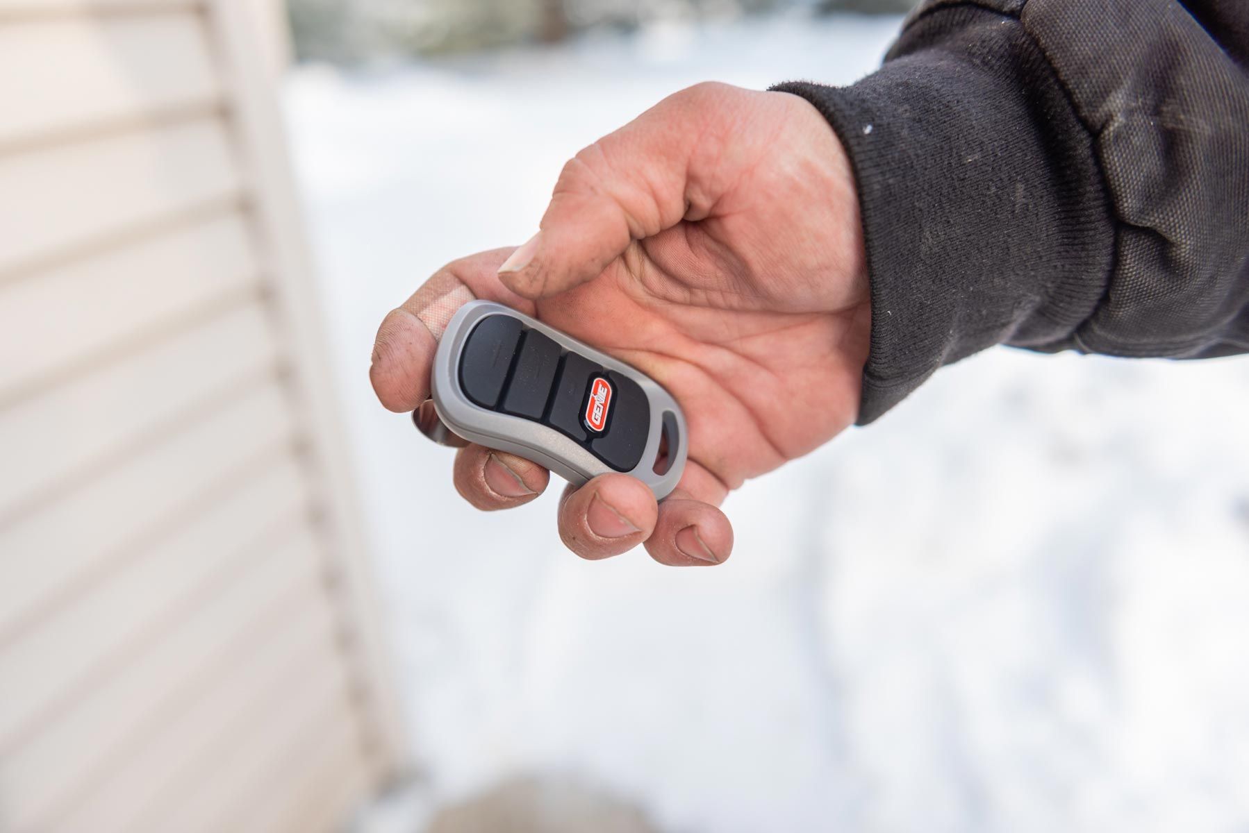 A person is holding a remote control in their hand.