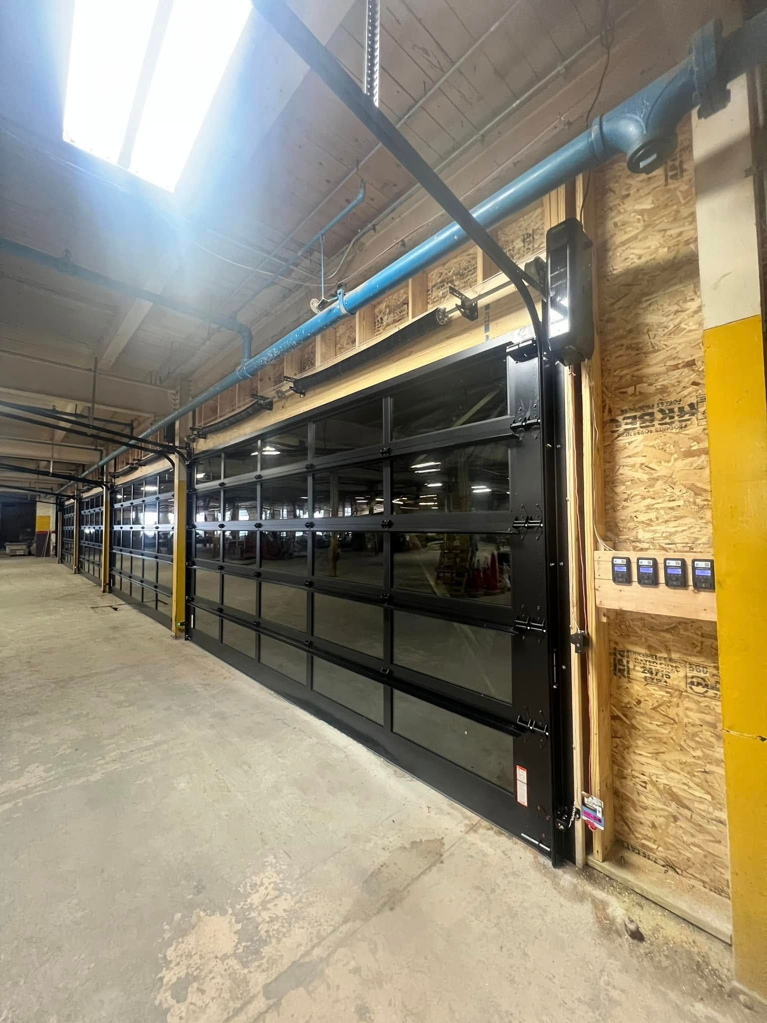 A large garage door is being installed in a building.