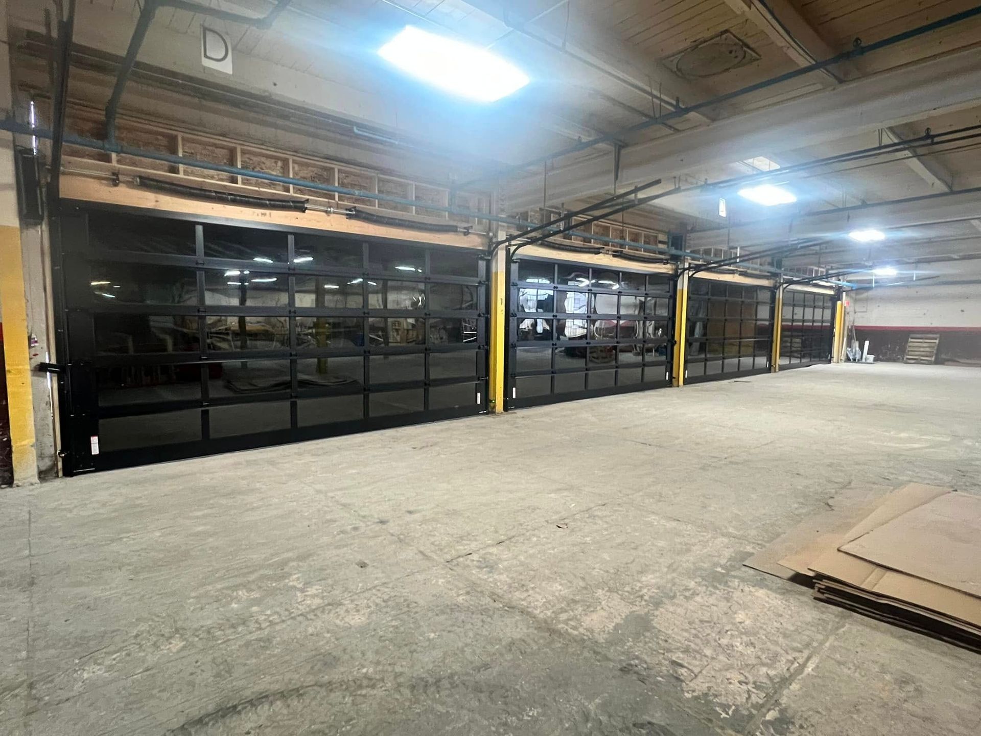 A large warehouse with a lot of doors and a lot of windows.