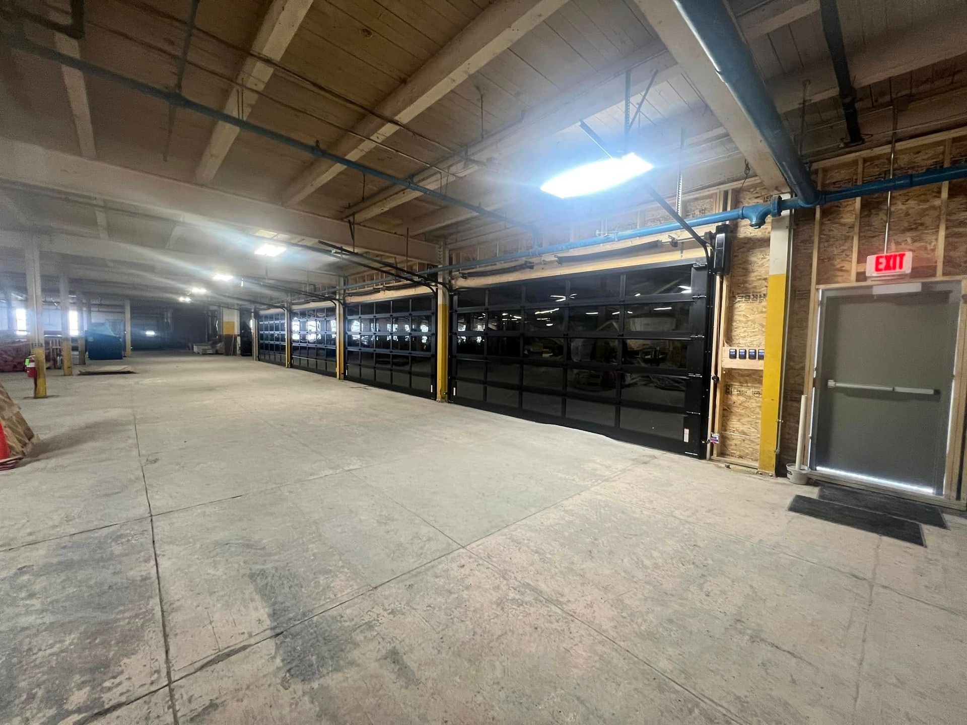 A large empty building with a lot of windows and doors.