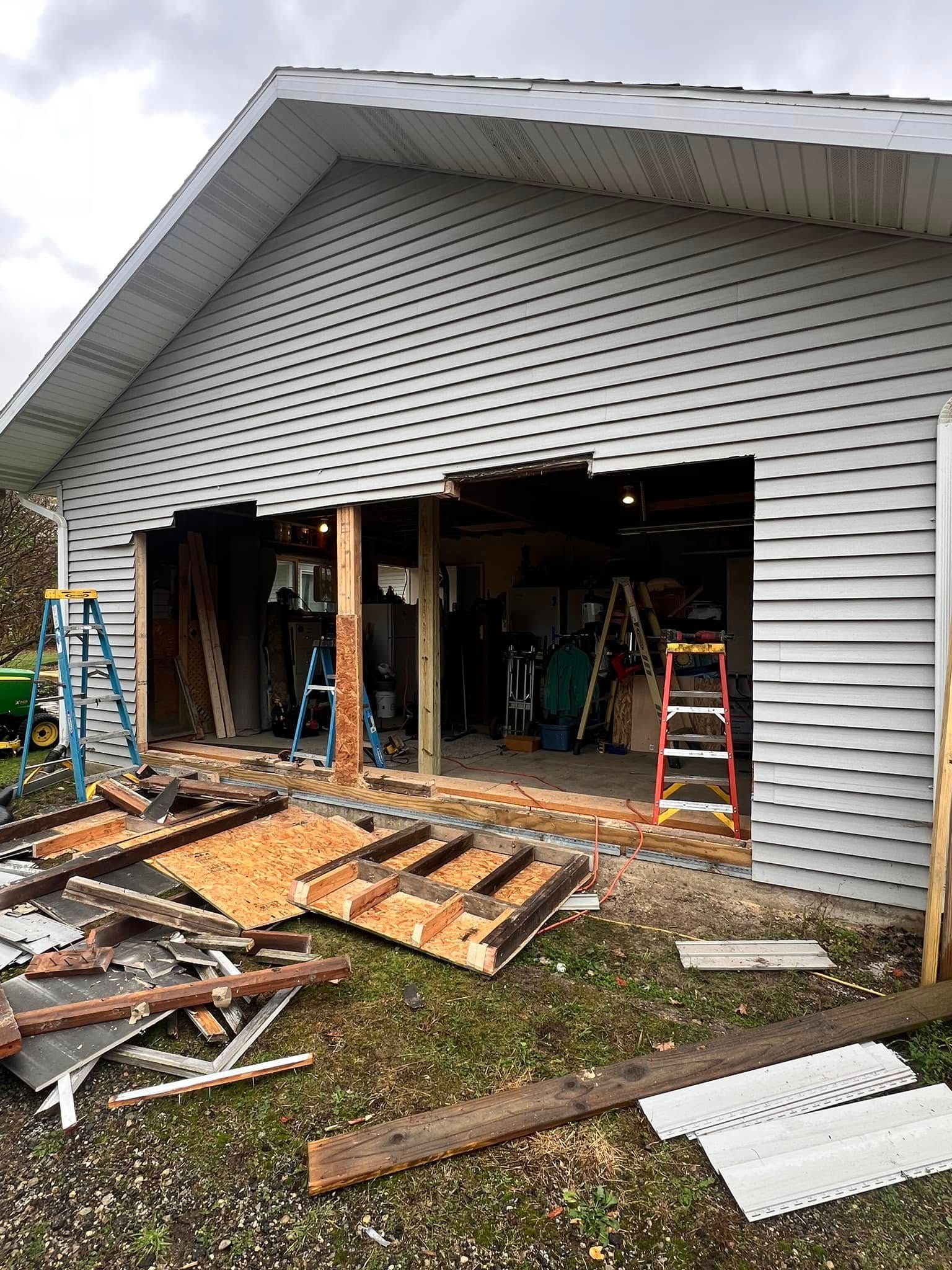 A garage door is being removed from a house.