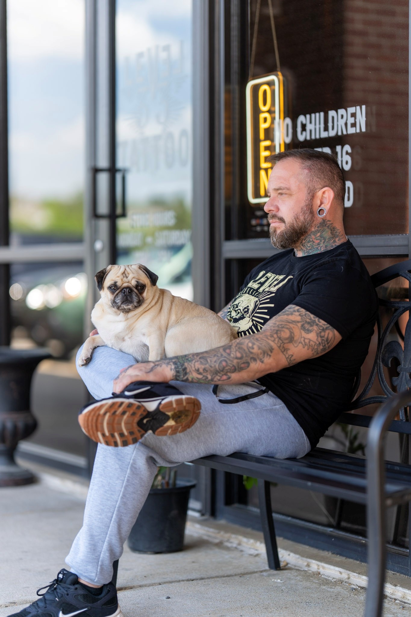 Marc, a tattoo artist with his dog pug.