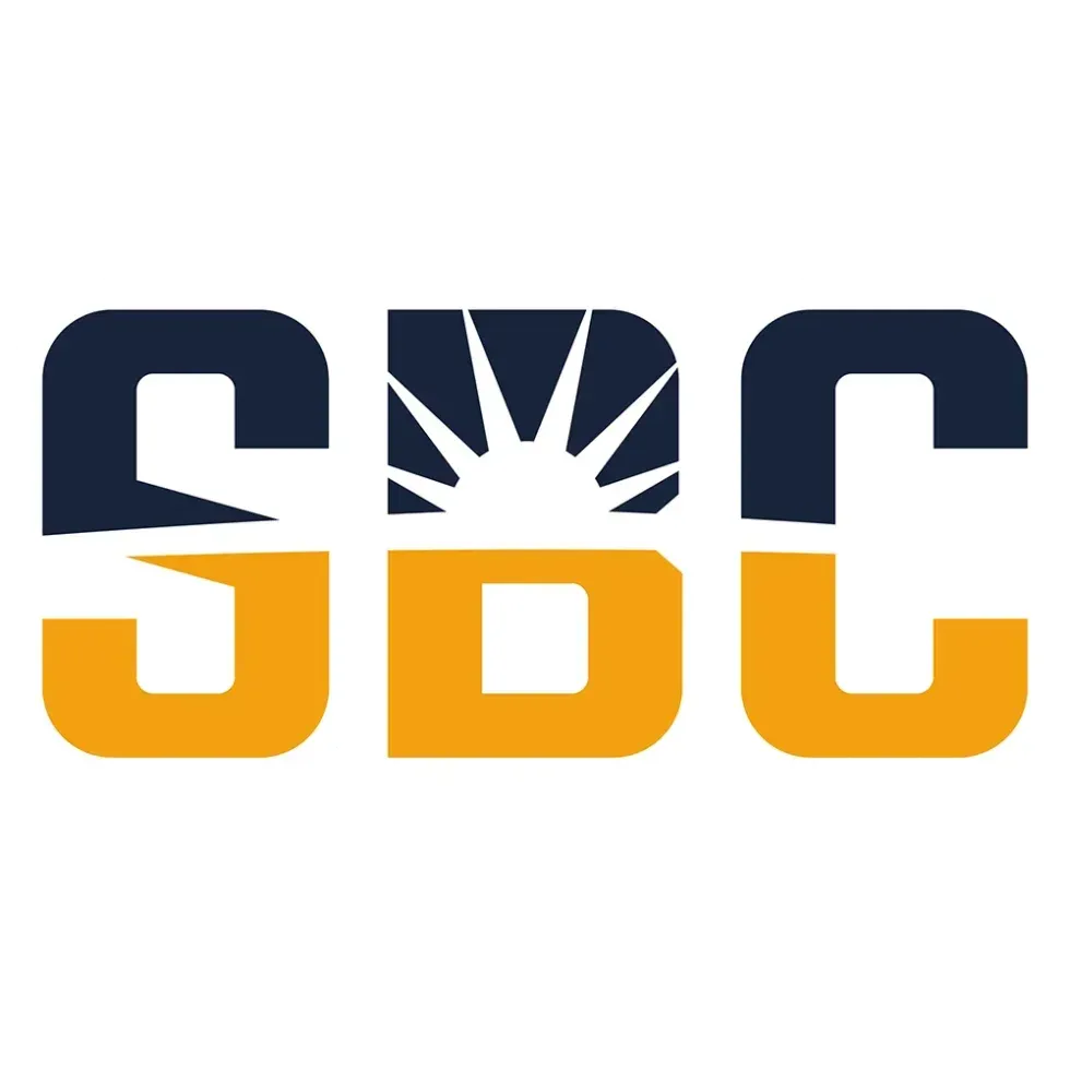 SBC logo in dark blue and gold with a white sunburst in the center of the B