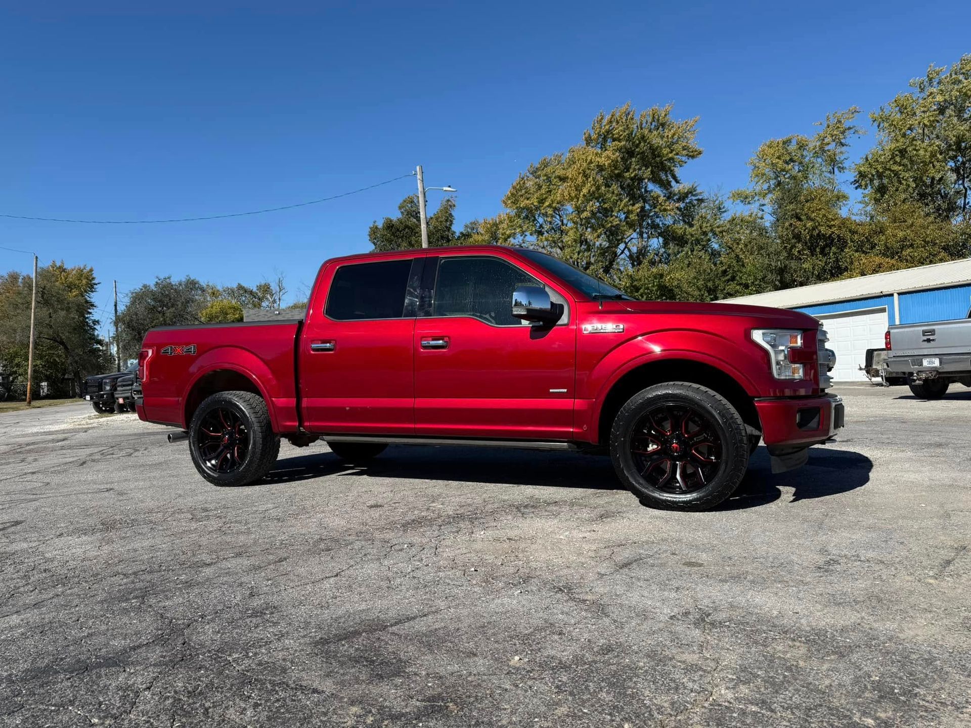 A red pickup truck is parked in a parking lot.