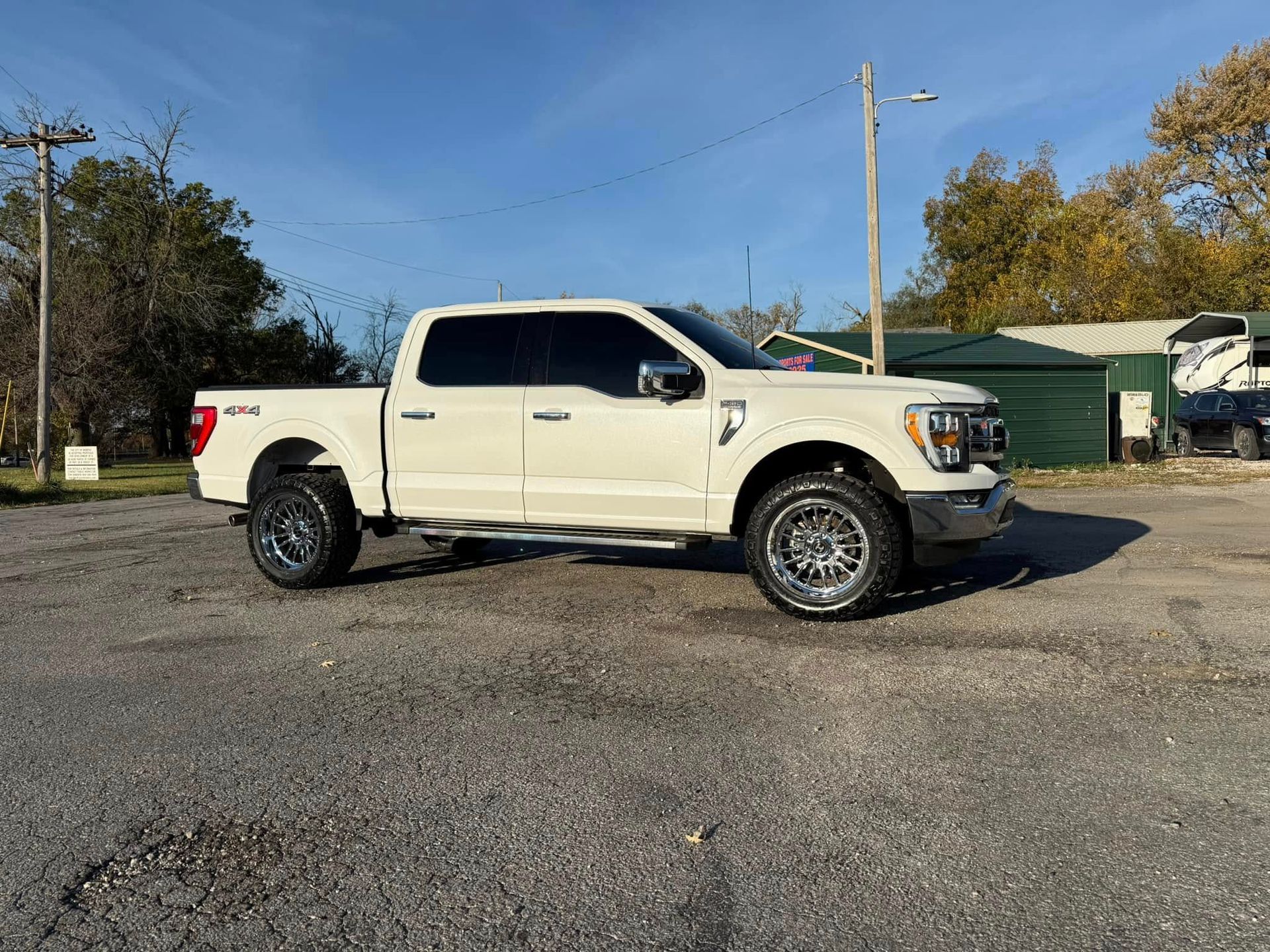 A white pickup truck is parked in a parking lot.