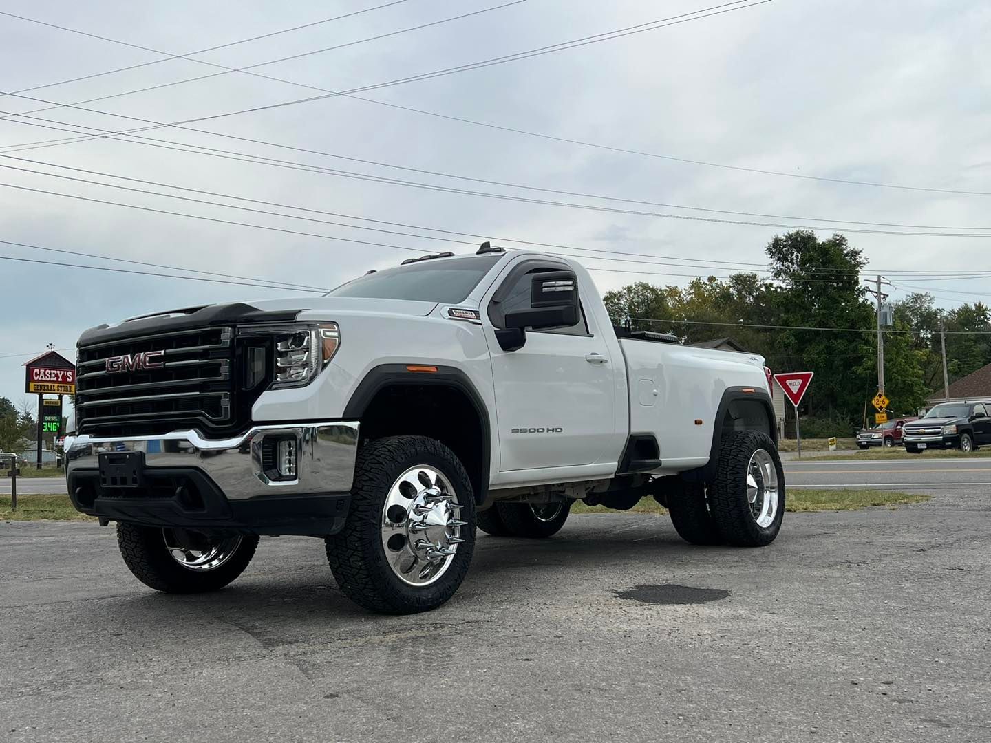 A white truck is parked on the side of the road.