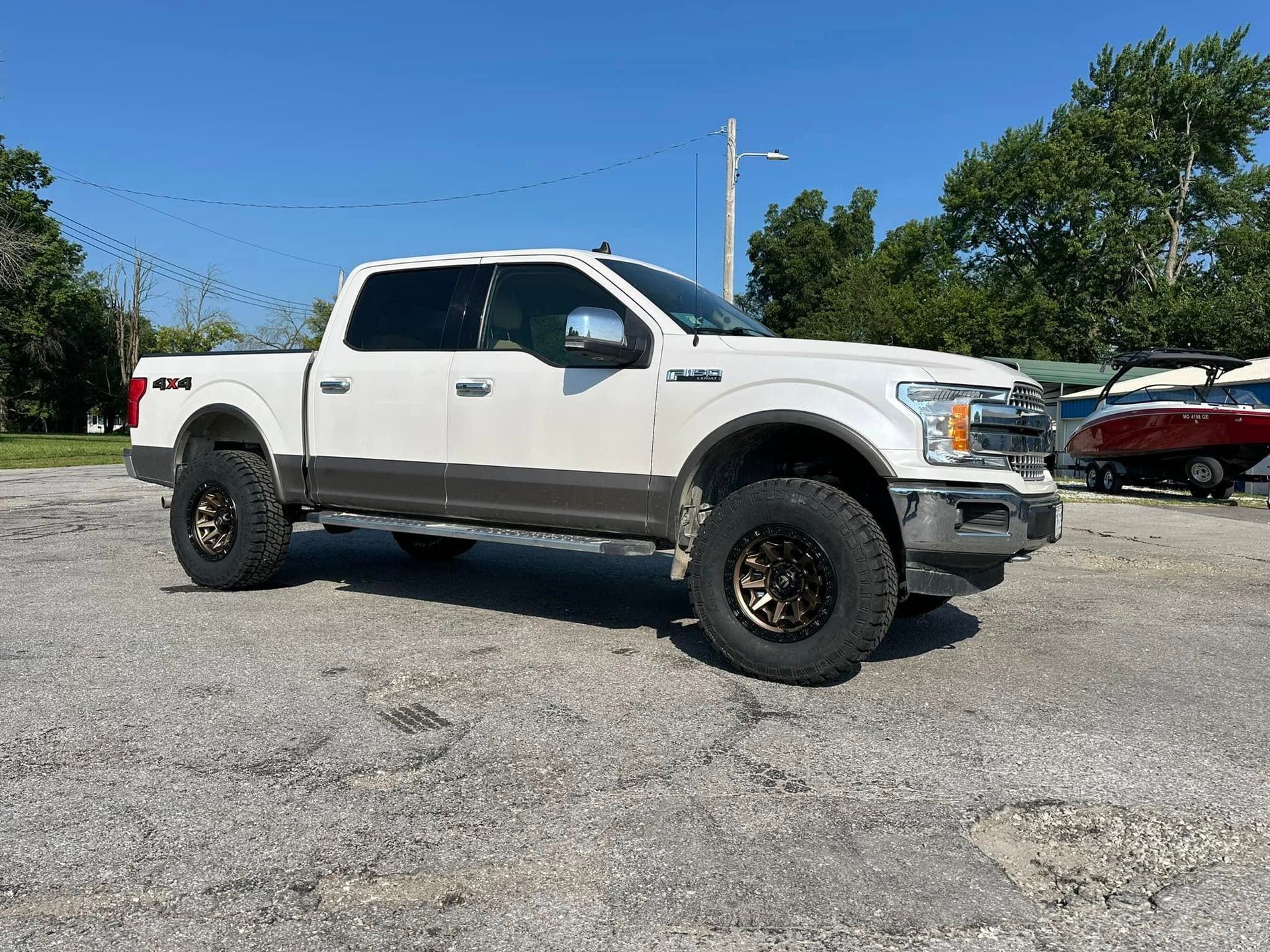 A white pickup truck is parked in a parking lot.
