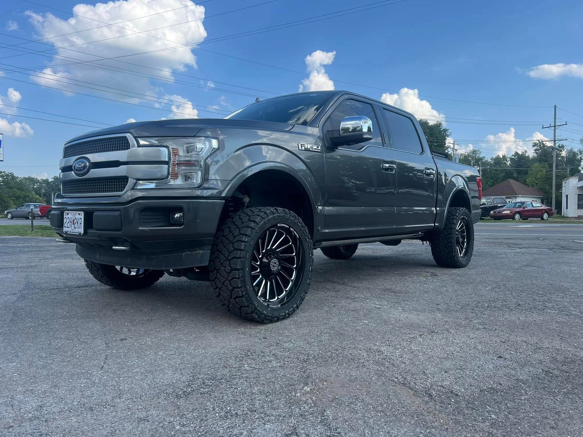 A ford f150 is parked in a parking lot on a sunny day.