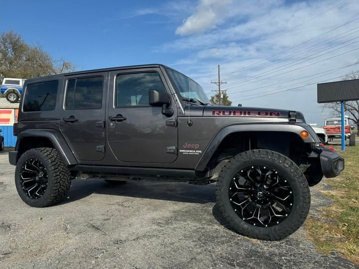 A jeep wrangler is parked in a parking lot.