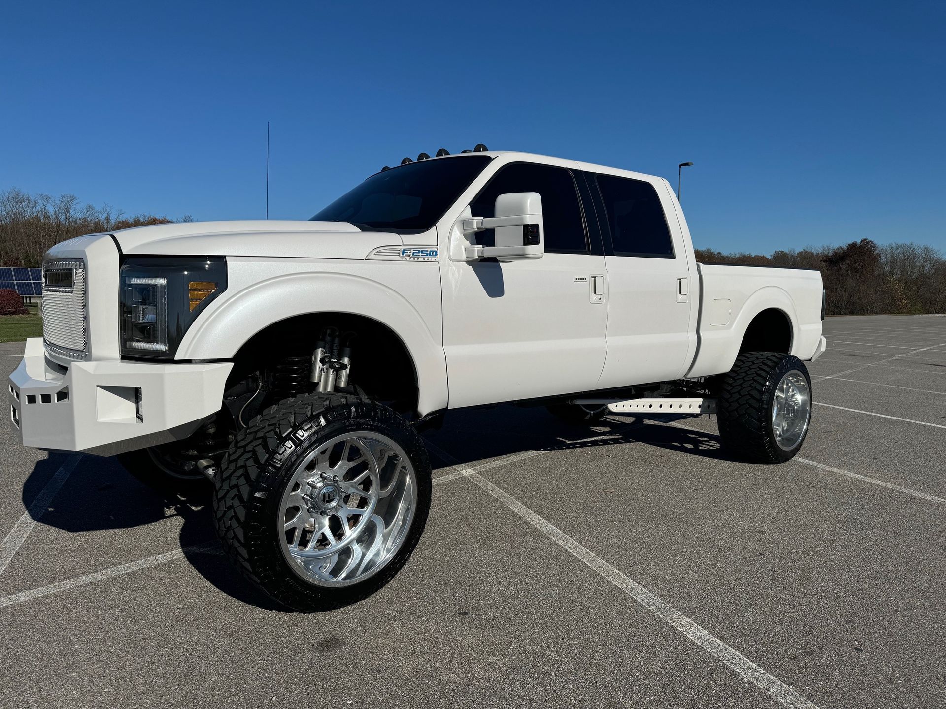 A white pickup truck is parked in a parking lot.