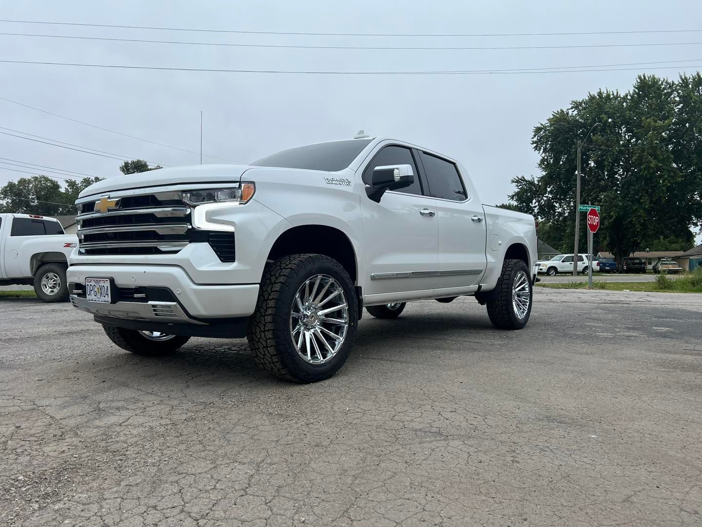 A white truck is parked in a parking lot.