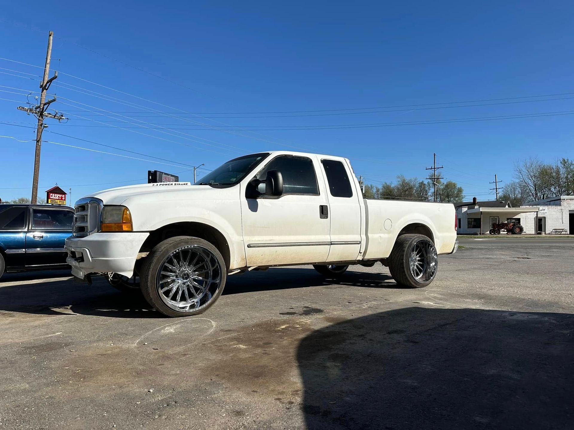 A white pickup truck is parked in a parking lot.