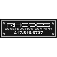 Rhodes Construction Company logo on a black and gray rectangular plaque with a phone number.