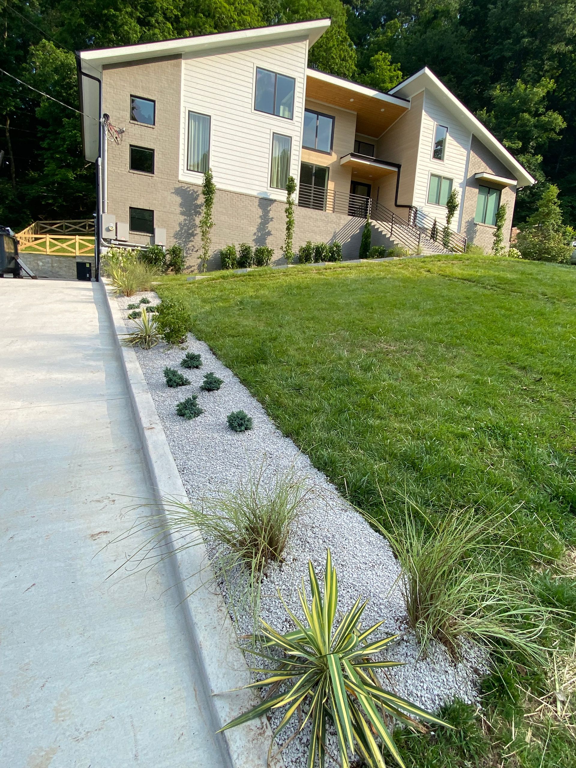 A large house with a lush green lawn in front of it.