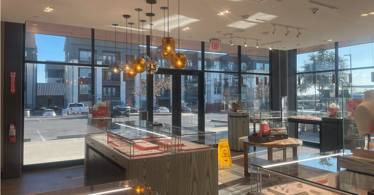 A jewelry store with a lot of windows and display cases.