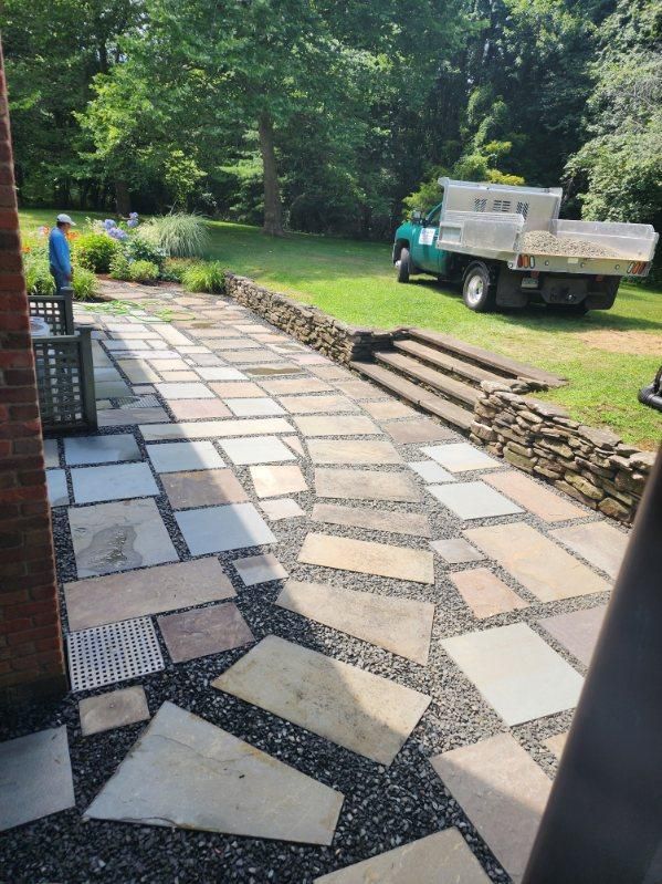 A truck is parked on the side of a stone walkway