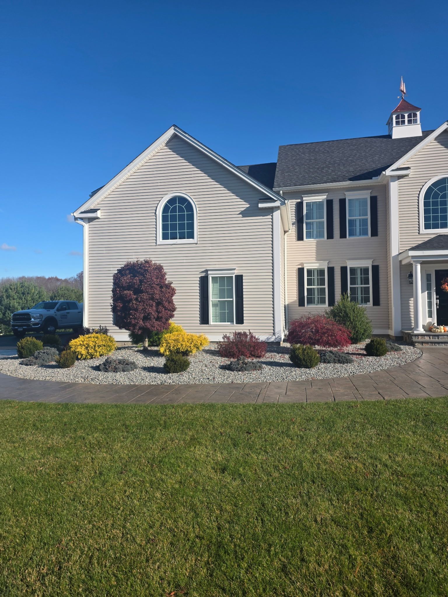 House exterior with landscaping and blue sky.