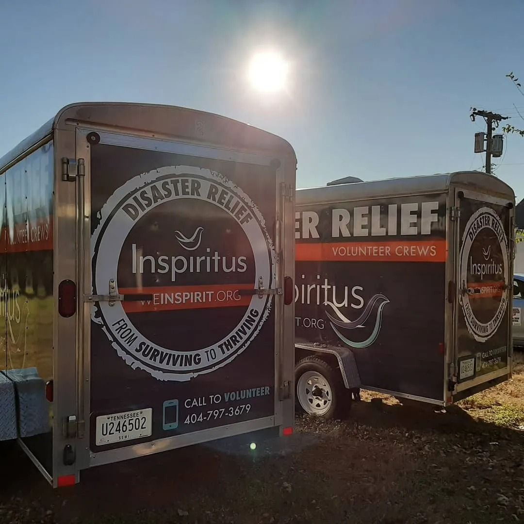 Two silver cargo trailers parked outdoors, displaying 