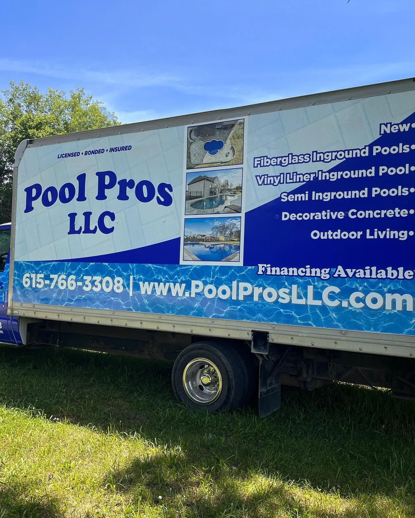 A Pool Pros LLC box truck parked on grass, featuring company branding, contact details, and photos of swimming pools.