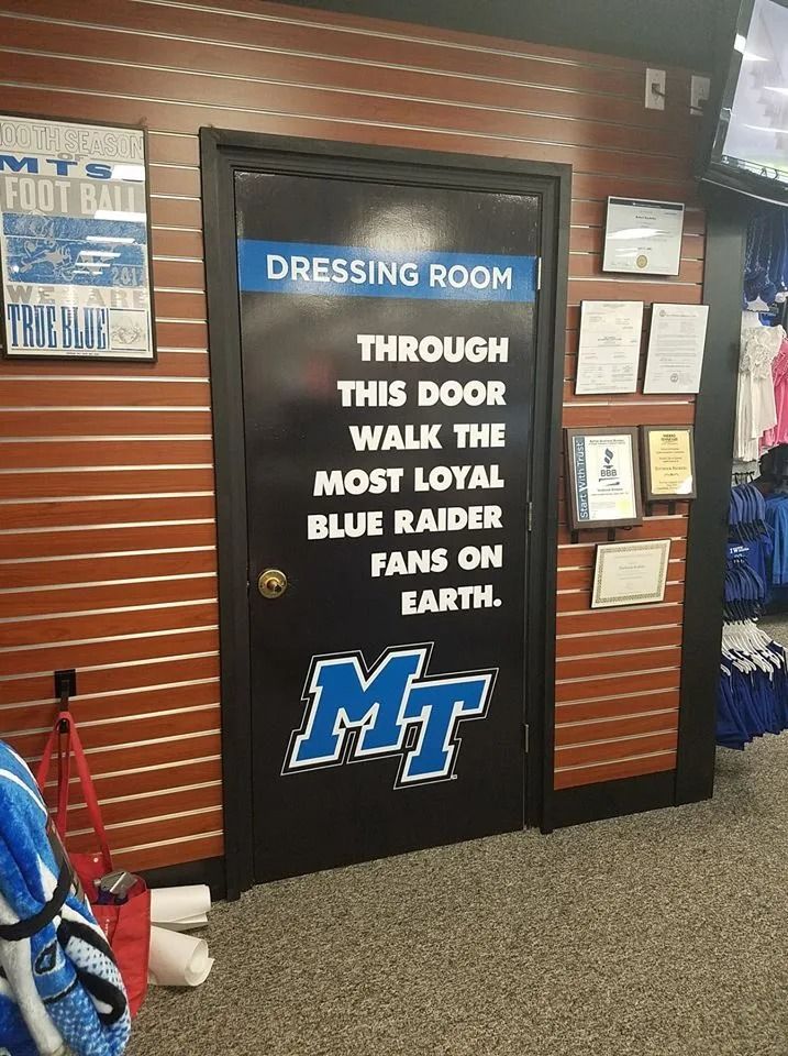 A black door in a store with text reading, 