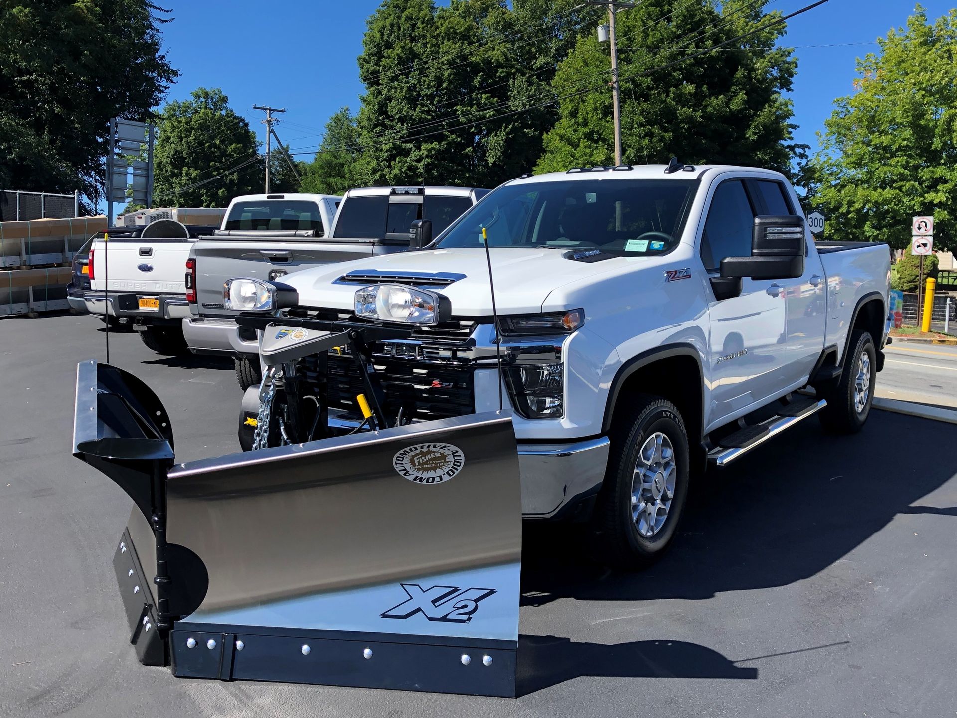 A white truck with a snow plow attached to it