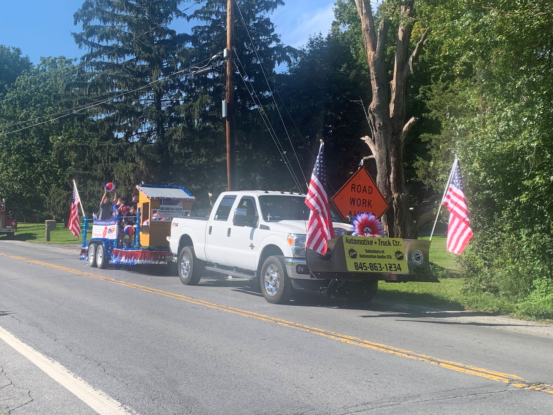 A white truck is parked on the side of the road