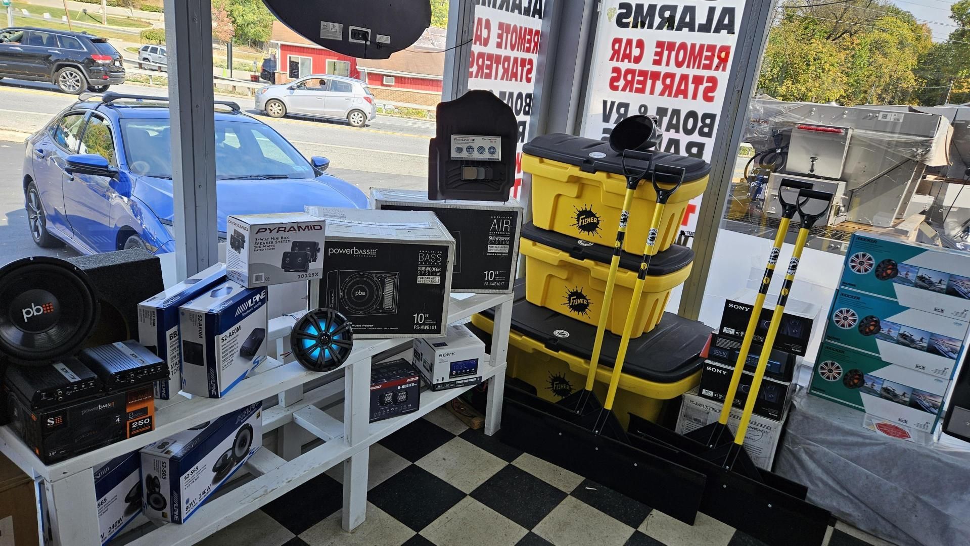 A store filled with lots of car accessories and a car in the background.