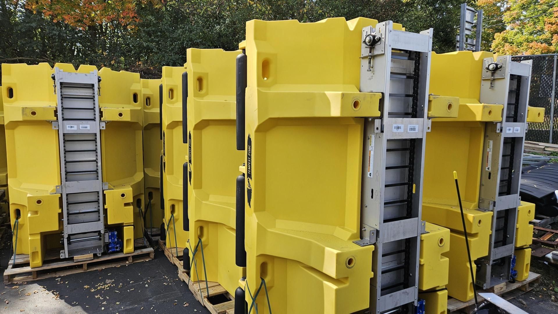 A bunch of yellow blocks are stacked on top of each other on pallets.