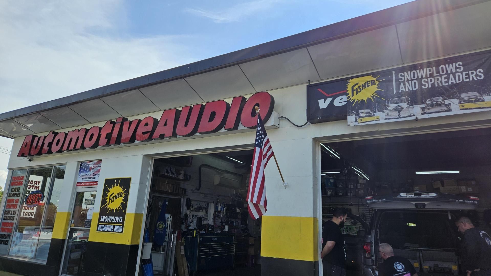 A man is working in an automotive audio store.