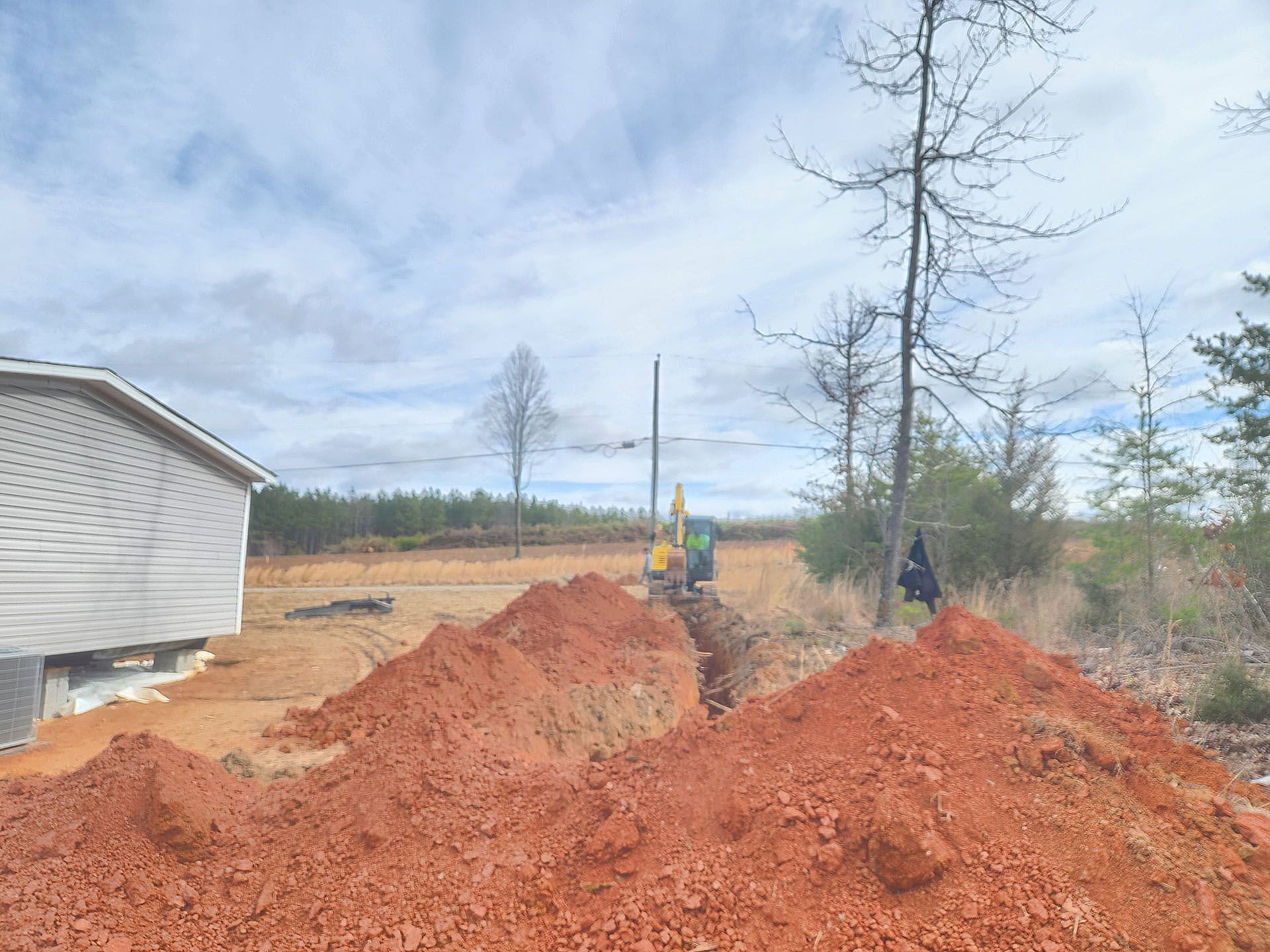 A pile of dirt is sitting in front of a house.