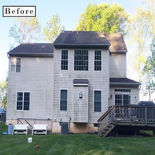 A before picture of a house with a deck