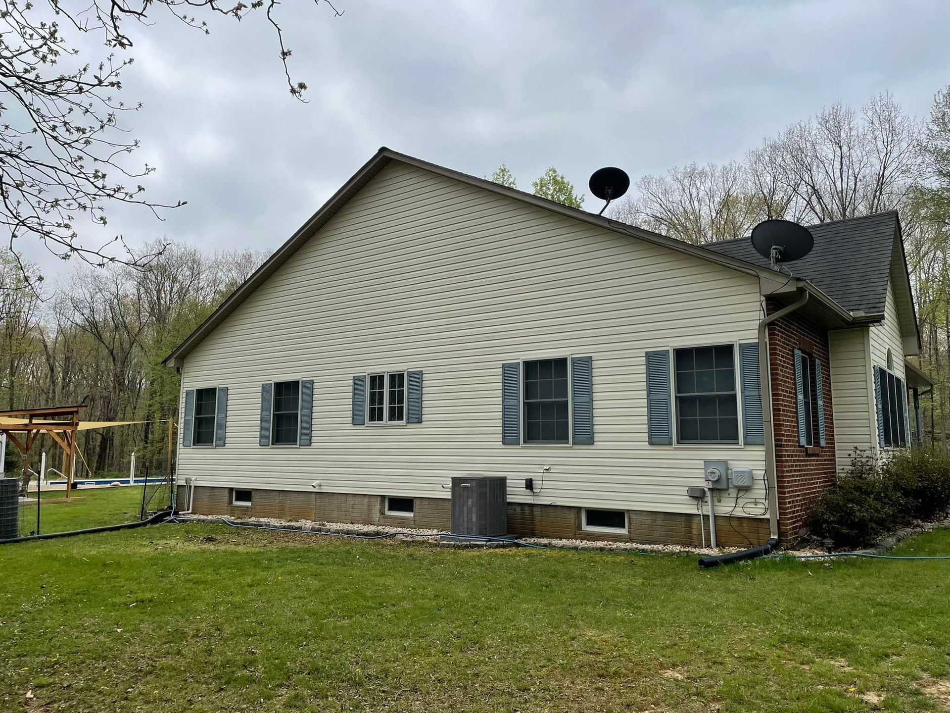 The back of a house with a lot of windows and shutters