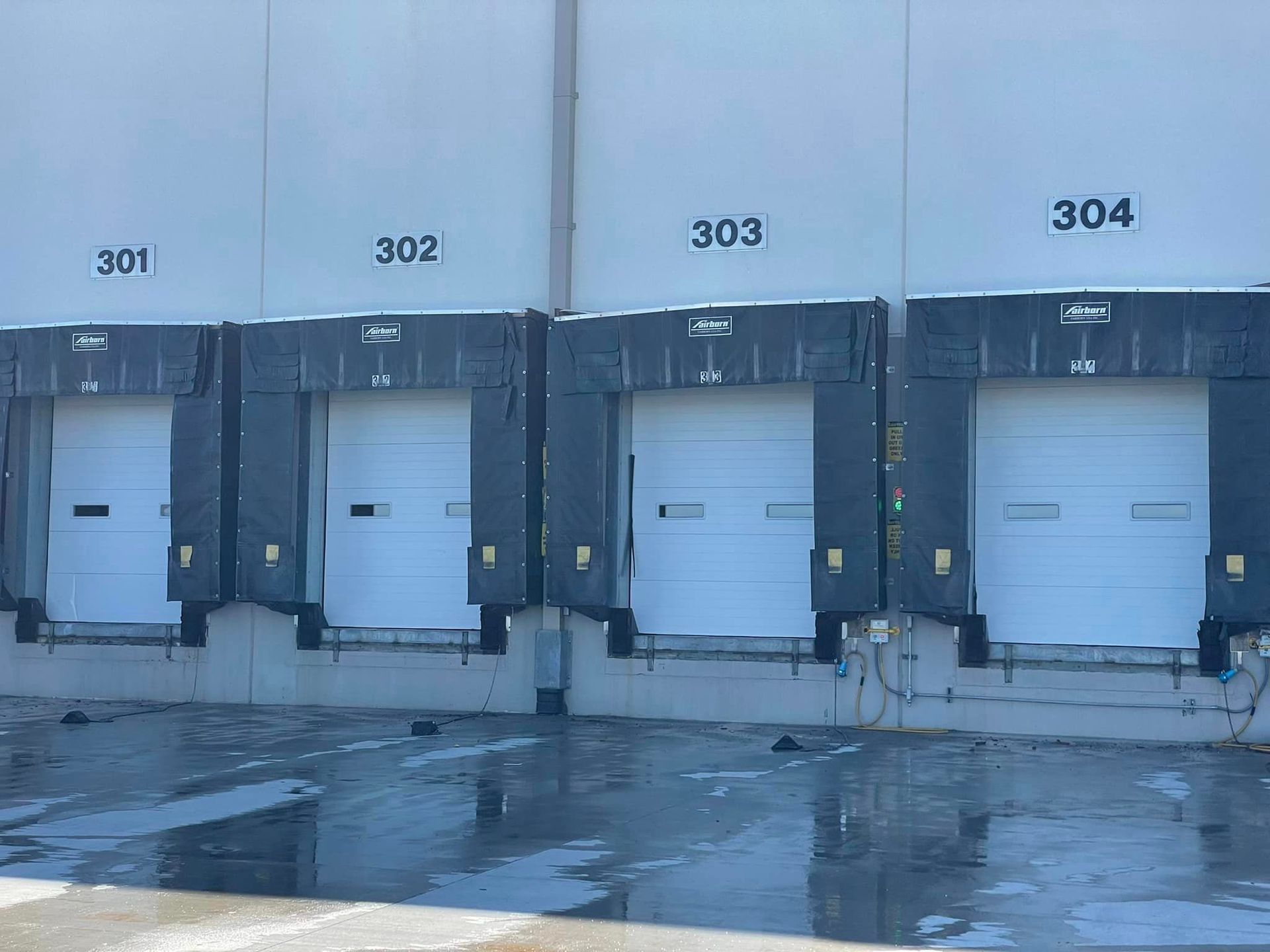 A row of loading docks with the numbers 301 302 303 and 304 on them