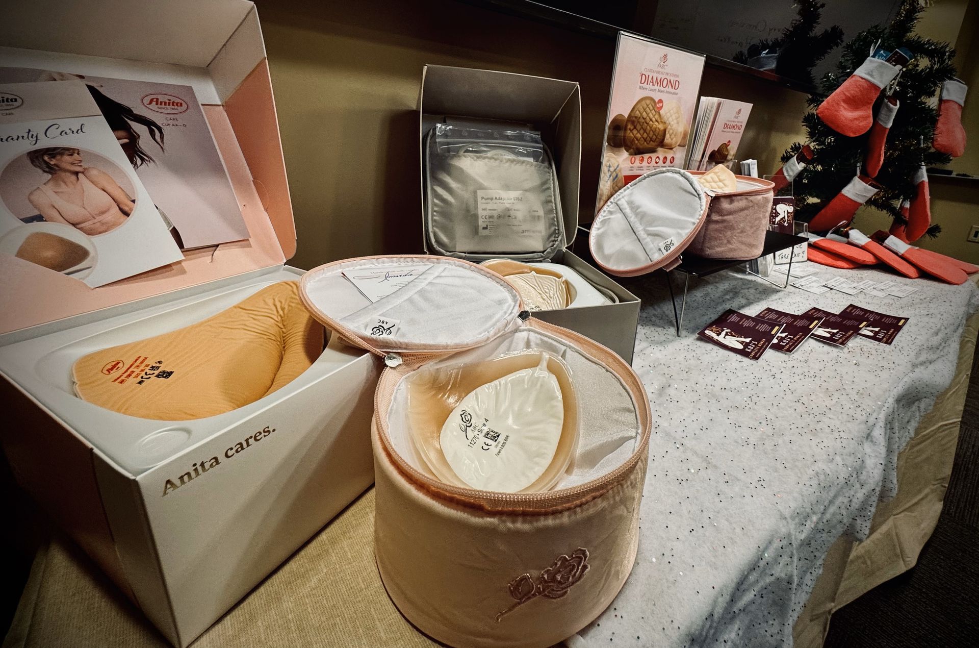 A table with boxes and a christmas tree in the background