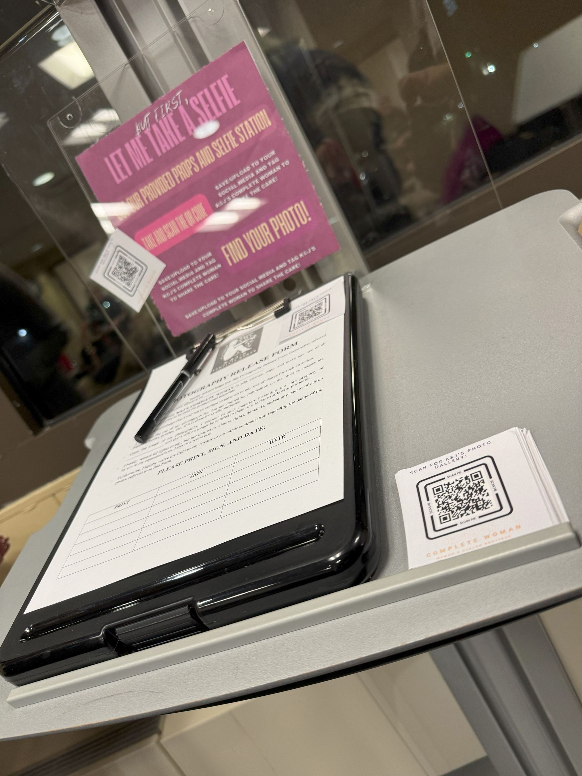 A clipboard with a pen and a qr code on it